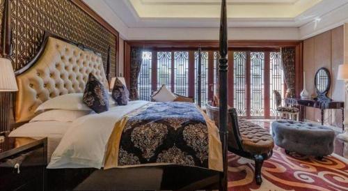 a bedroom with a large bed and a large window at Eden Club House in Tongxiang