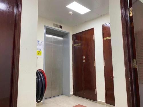 a hallway with three elevators in a building at Darlene Hotel in Singapore