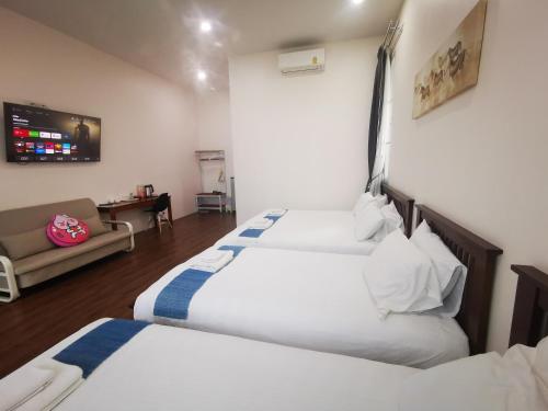 Postel nebo postele na pokoji v ubytování บุญเมืองน่าน