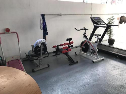 a gym with several exercise equipment in a room at Lai Ming Hotel Cosmoland in Singapore