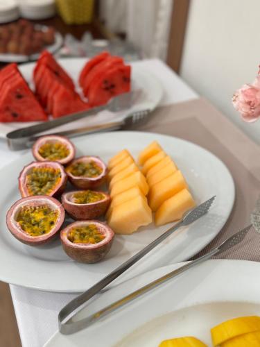 a plate of food with fruit on a table at Five Star Westlake 1st-4th Floors Hotel & Serviced Apartment in Hanoi