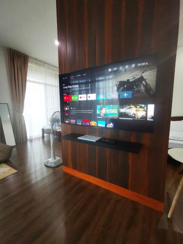 a large flat screen tv on a wooden wall at บุญเมืองน่าน in Nan