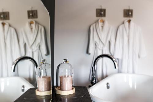 a bathroom with two sinks and two mirrors at B&B La Maison de Julia in Albi
