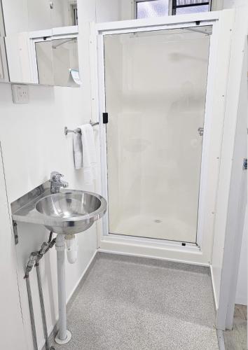 a bathroom with a sink and a shower at Hive Hotel, Moruya in Moruya