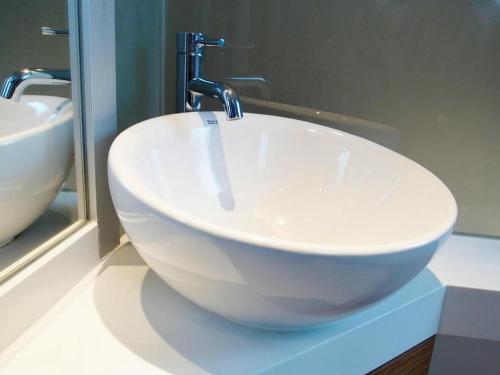 a sink with a faucet in a bathroom at Acesite Knutsford Hotel in Hong Kong