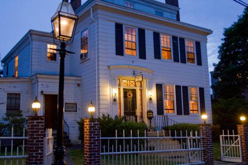 a white house with a street light in front of it at Historic Hill Inn in Newport