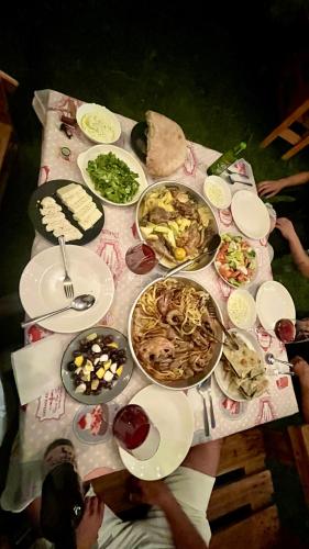a table with many plates of food on it at Velaj Guest House in Cfir