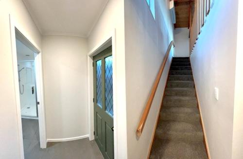 a staircase in a house with a green door at Room with a View in Kinloch