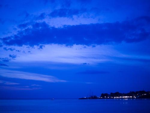 a blue cloudy sky over a body of water at Olive Press Hotel in Mithymna