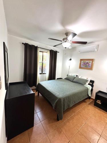 a bedroom with a bed and a ceiling fan at Condo Morpho with 2bed 2 baths in Coco
