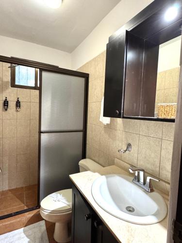a bathroom with a sink and a toilet and a shower at Condo Morpho with 2bed 2 baths in Coco