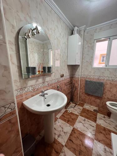 a bathroom with a sink and a mirror at Lima in Orihuela Costa
