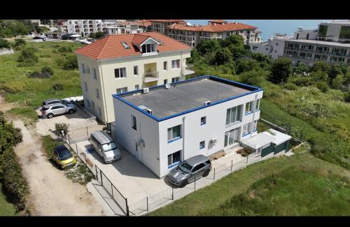 a large white house with cars parked in front of it at Victoria in Byala
