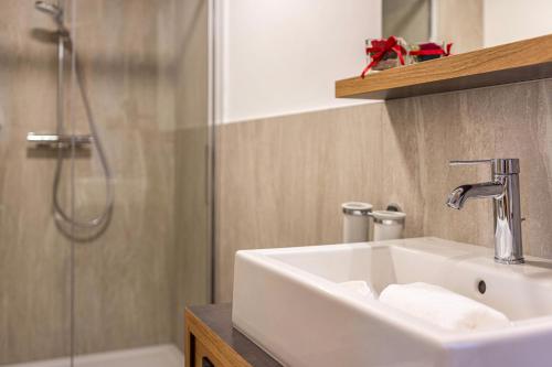 a bathroom with a sink and a shower at Planerhof Apartment Alpenrose in Funes