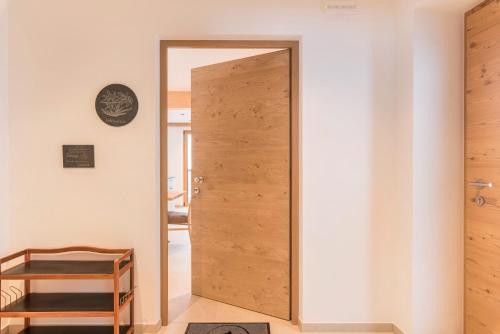 a door in a room with a white wall at Planerhof Apartment Edelweiss in Funes