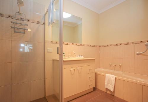 a bathroom with a shower and a sink at On The Trail in Bright