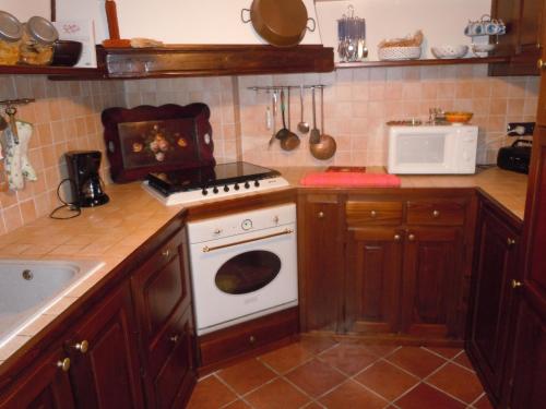 a kitchen with a stove and a white oven at B&B Il Mulino in Sanfront