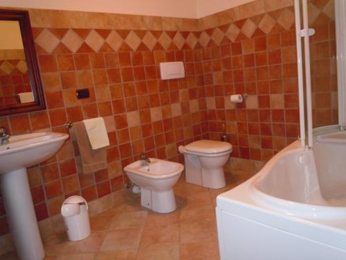 a bathroom with a toilet and a sink and a tub at B&B Il Mulino in Sanfront