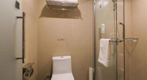 a bathroom with a toilet and a glass shower at GRACE Select Hotel (Kunshan Huaqiao International Convention Center) in Suzhou