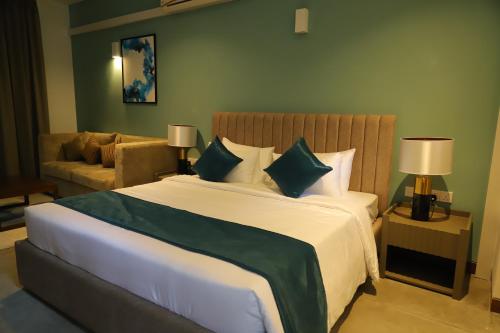 a bedroom with a large bed and a couch at Victoria Golf Resort in Digana