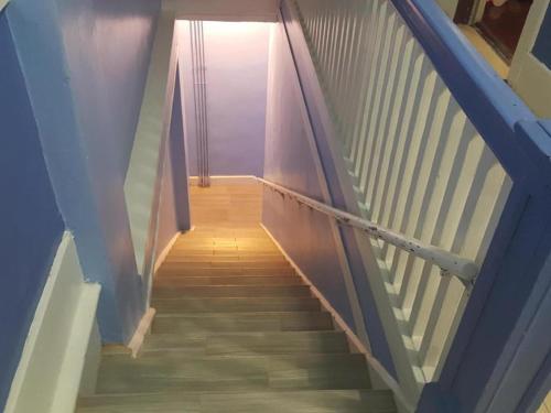a hallway with stairs with a light at the top at Desmond Hotel in San Francisco