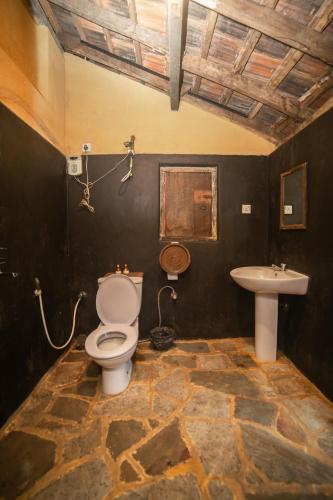 a bathroom with a toilet and a sink at The Kandy Samadhicentre in Kandy