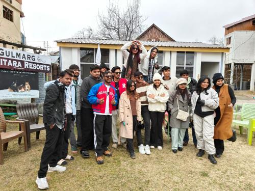 a group of people posing for a picture in front of a house at Gulsitara Resorts-Gulmarg in Gulmarg
