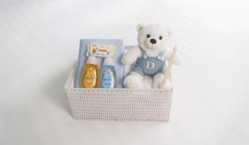 a basket with a teddy bear and toothbrushes and a stuffed teddy at Dorsett Mongkok, Hong Kong in Hong Kong