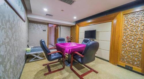 a dining room with a purple table and chairs at Zhongshan Louis Hotel in Zhongshan