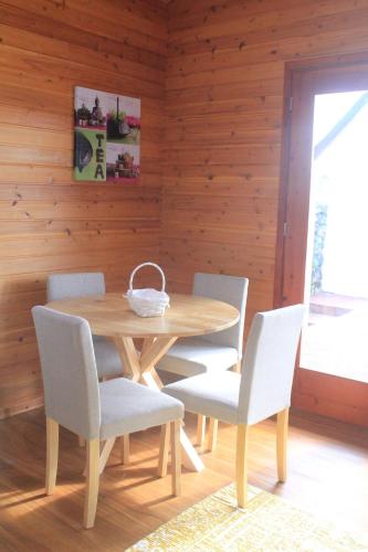 a wooden dining room with a wooden table and chairs at Casa dos Manos in Furnas