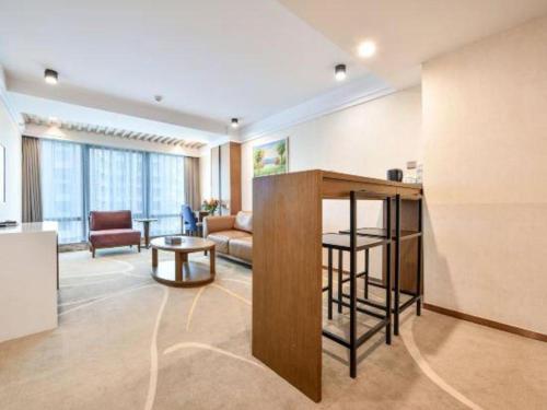a living room with a couch and a table at Dalian Bohai Pearl Hotel in Dalian