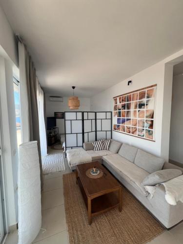 a living room with a couch and a table at Sea View Apartments in Herceg-Novi