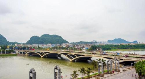 a bridge over a river next to a city at Guilin Manhatton Hotel Tianjie in Guilin