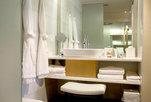 a bathroom with a toilet, sink and mirror at Islington Hotel in Hobart