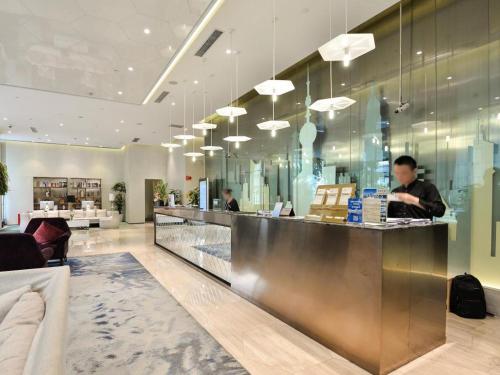 un ristorante con un bancone con due persone dietro di Shanghai Bund South China Harbour View Hotel a Shanghai