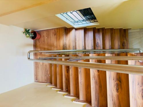 a row of wooden stairs in a room with a window at Sevrina Beach INN in Calangute