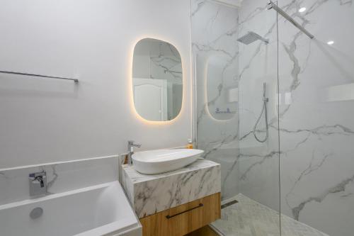 a white bathroom with a sink and a mirror at San Lameer Villa 2027 - 2 Bedroom Superior - 4 pax - San Lameer Rental Agency in Southbroom