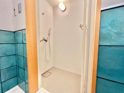 a bathroom with a shower with blue tiles at Cruz Del Sur - Vacation STAY 11190v in Ishigaki Island