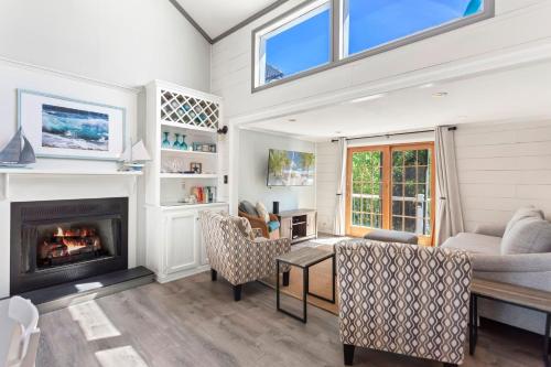 a living room with a couch and a fireplace at 1689 - Maison de la Mer in Poplar Branch