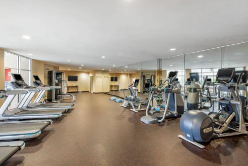 a gym with a bunch of treadmills and machines at Cambria Hotel Akron - Canton Airport in Uniontown