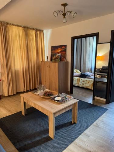 a living room with a coffee table and a bedroom at Guest house in Otopeni