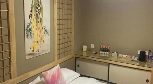 a hotel room with a reception desk and a bed at Beijing Inner Mongolia Hotel Chaoyang in Beijing
