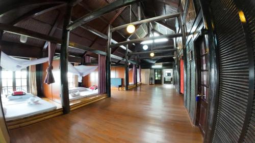 a room with two bunk beds and a wooden floor at Handspan Homestay Sapa in Sa Pa