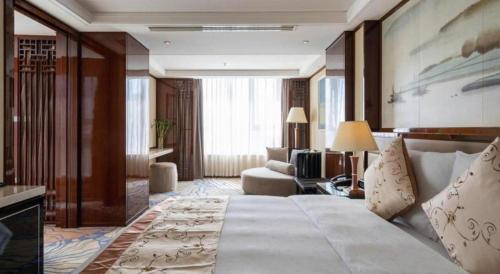 Ένα ή περισσότερα κρεβάτια σε δωμάτιο στο Yang Peng Jin Jiang Hotel