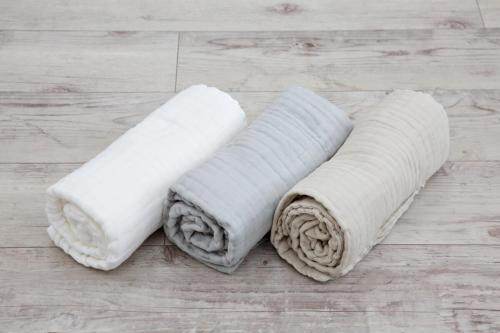 two white towels sitting on a wooden floor at Oliver 502 in Tokyo