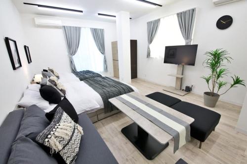 a bedroom with a large bed and a couch at Oliver 502 in Tokyo