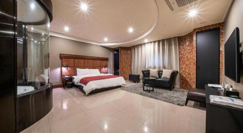 a hotel room with a bed and a bathroom at Hotel Floce in Bucheon