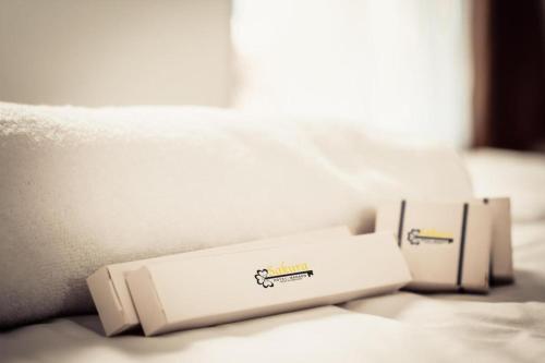 two white boxes sitting on top of a bed at Sakura Manado in Manado