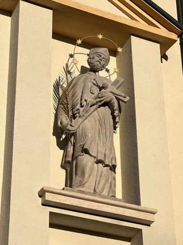 a statue of a god on the side of a building at Feltlův mlýn v Borovnici in Borovnice