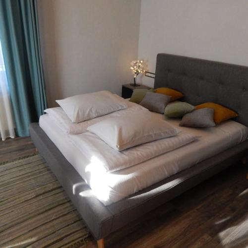 a bed with pillows on it in a room at At the old blacksmith in Daugavpils